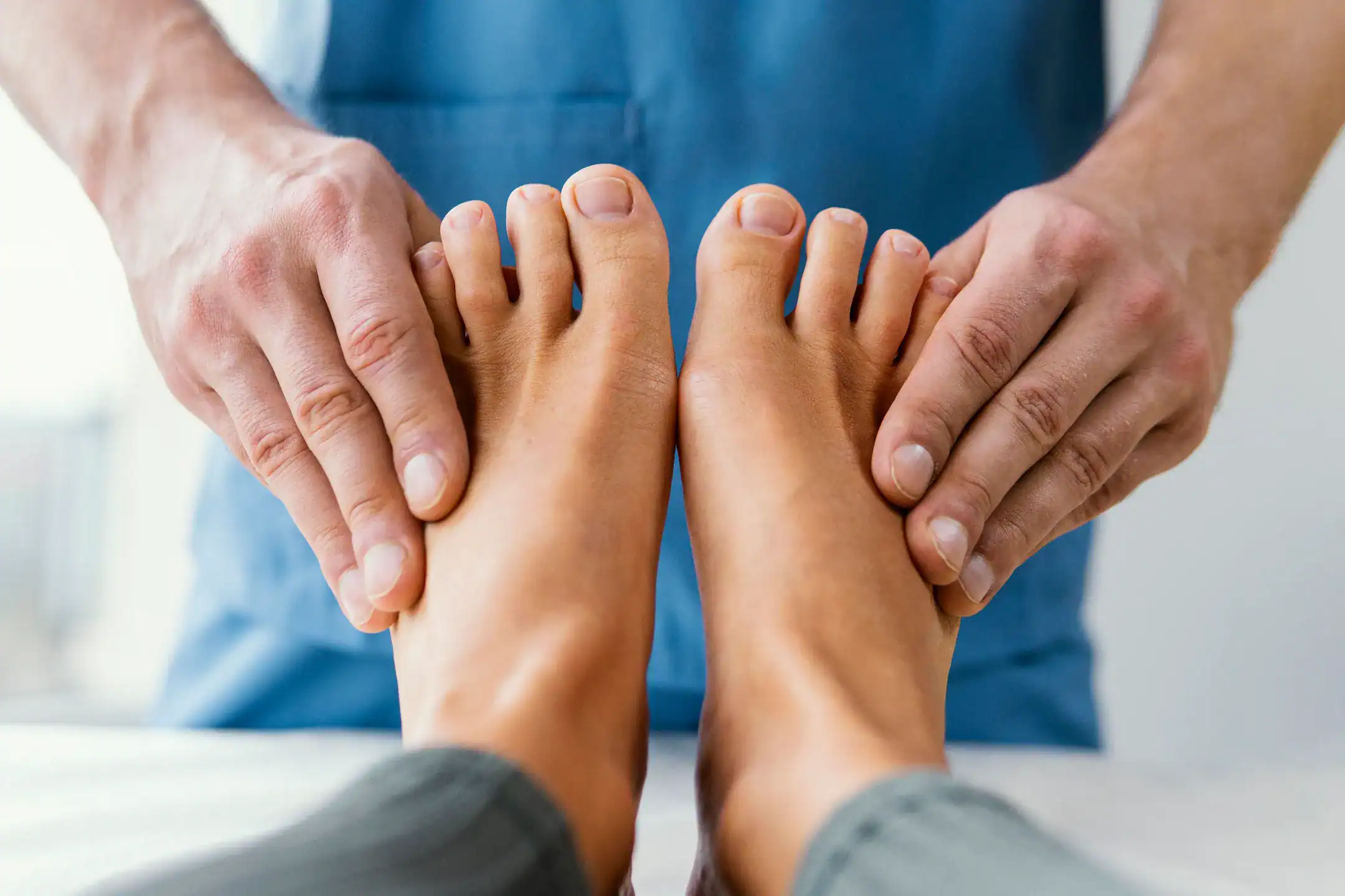 front view male osteopathic therapist checking female patient s toes